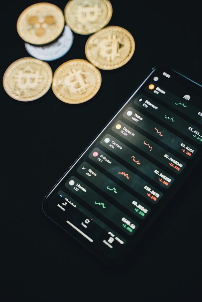 Smartphone showing cryptocurrency exchange app with bitcoin coins in the background, conveying digital finance.